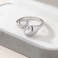 Detailed view of silver fluid snake ring with organic pebble shapes on jewelry display box - One Size(Adjustable) / Silver