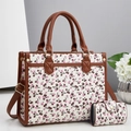 Détail du sac blanc à motif cerise avec poignées en cuir marron et petite pochette assortie - Blanc Cassé