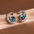 Macro detail of crescent moon earrings with blue star stone and glittering zircon stones - Silver Starry Earrings (EP6132)