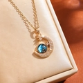 Macro shot of gold crescent moon necklace featuring blue starry galaxy stone and zircons - Gold Starry Pendant Necklace (ZPN535)