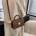 Brown crocodile texture crossbody bag shown being worn by a model in a minimalist setting - Red Brown