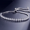 Adjustable silver tone tennis bracelet with 4mm round crystals and slider clasp - White