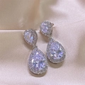 Elegant silver-toned water drop earrings featuring pear-cut zircon stones with halo detail - White