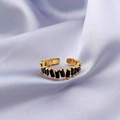 Adjustable gold plated ring featuring rectangular black zircon stones on a purple silk background - Black Zirconia Gold Plated