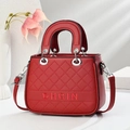 Detail of red quilted handbag with DHGIN embroidery and silver hardware rings - 24cm x 9cm x 18cm / Wine Red