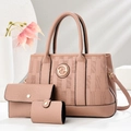 Three-piece pink textured tote bag set with matching wallet and pouch in minimalist setting - Pink