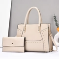 Detail of beige striped tote bag and clutch set with gold rivets and adjustable strap - Beige