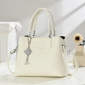 Minimalist beige lychee pattern shoulder bag with silver pendant and dual handles - Off-white
