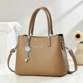 Detail of brown lychee texture leather handbag with pearl chain and silver pendant - Khaki