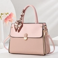 Detail of pink handbag with textured weave base and decorative houndstooth scarf on handle - Pink