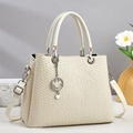 Detail of cream woven tote bag with silver smiley pendant and adjustable strap - Off White