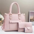 Detail of pink three-piece bag set with litchi grain texture and gold hardware - Pink