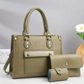 Detailed close-up of dark green crossbody bag set with embossed weave texture and silver hardware - Green