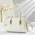 Detail of white crocodile texture evening bag with crystal clasp and gold metal frame - Off White