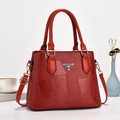 Detail of red leather bucket bag with MS.ISHIANG logo, stitching and gold hardware - Red