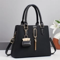 Black macaron style tote bag with gold hardware, tassel pendant, and crossbody strap - Black