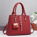 Burgundy striped woven handbag for women with tassel charm and micro pouch accessory - Red