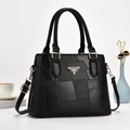 Chic black patchwork bucket bag with golden hardware and adjustable crossbody strap - Black