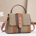 Detail of vintage striped woven handbag with leather trim and gold buckle closure - Earthy Yellow