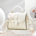 Borsa a mano bianca in pelle litchi con tracolla intrecciata e ciondolo in peluche su sfondo geometrico - Bianco Sporco