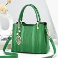 Emerald green wave-patterned handbag with golden leaf pendant and pearl detail - Emerald Green