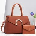 Detail of brown textured leather handbag set with gold ring hardware and shoulder strap - Earthy Yellow