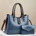Detail of vintage denim blue tote bag set with textured leather and silver rivet accents - Blue