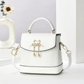 Detail of white crocodile pattern bag with swan heart lock and pearl pendant accent - White