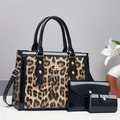 Detailed view of leopard print handbag set featuring golden interlocking metal buckle hardware - Khaki