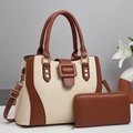 Close-up of straw woven tote set with leather trim and gold decorative buckle detail - Off-white