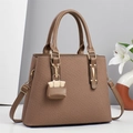 Brown striped woven handbag with cross-body strap and matching mini charm pendant - Brown