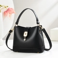 Elegant black lychee leather bucket handbag with gold feline charm and adjustable strap - Black