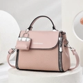 Elegant pink textured woven handbag with leather flap and hanging mini charm accessory - Pink