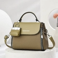 Elegant contrast leather handbag with woven texture and mini bag charm on stone pedestal - Green