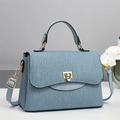 Elegant light blue handbag with vertical wave texture and gold hardware on white background - Blue / L25 W11 H17