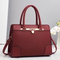 Elegant wine red pleated faux leather handbag with gold hardware and adjustable strap - Red