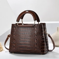Dark brown faux crocodile leather handbag with golden hardware and top handle design - Brown