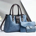 Detailed view of the blue three-piece bag set with textured leather and metal buckles - Blue