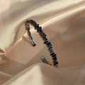 Modern silver bangle with geometric black zircon inlay on a champagne silk background - Gun Black