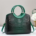 Detail view of green crocodile pattern tote bag with gold studs and adjustable strap - Green