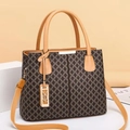 Detail of premium brown patterned tote bag with gold hardware and adjustable strap - Earthy Yellow