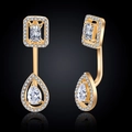 Detail of gold geometric earrings featuring square and teardrop cubic zirconia stones - Earrings / Gold
