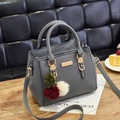 Grey pebbled leather crossbody bag with dual handles and tricolor fuzzy charm - Dark Gray