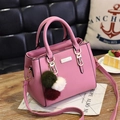 Pink lychee texture crossbody bag with tricolor pompom charm and top handles - Pink