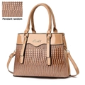 Detail view of khaki handbag featuring lizard texture contrast and metallic logo - Khaki