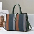 Close-up of tricolor woven texture with green leather trim and golden metal clasp - Green