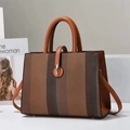 Detail of striped canvas tote with brown leather handles and golden metal buckle clasp - Earthy Yellow