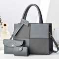 Three-piece dark grey tote bag set with textured patchwork and gold hardware details - Gray