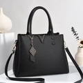 Detail of black pebbled leather tote bag with V-shaped metal trim and handle - Black