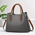 Detail view of large grey tote bag with brown handles and Fashion Queen text - Gray